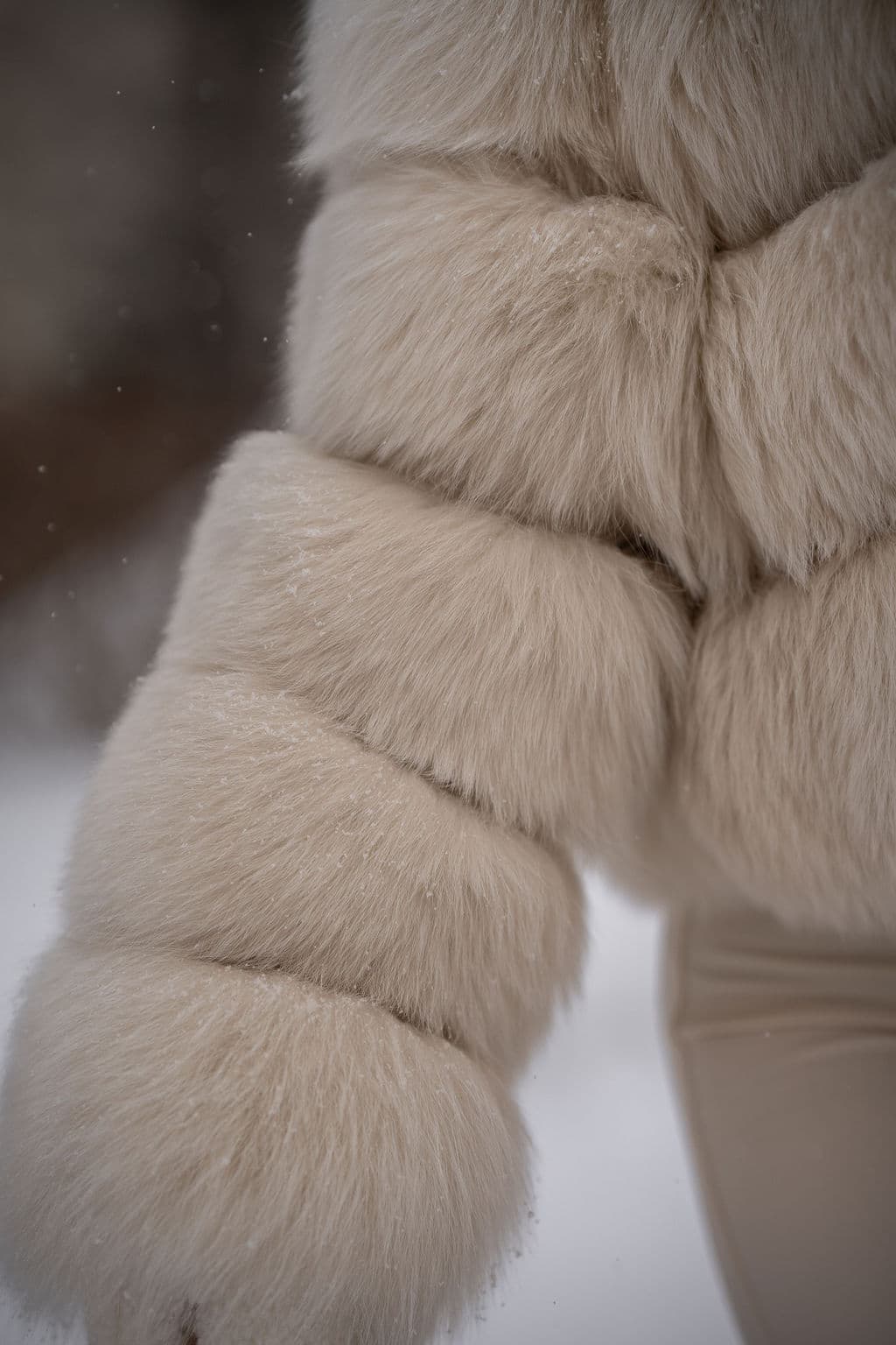 Close detail of banded ivory fox fur on a jacket sleeve.