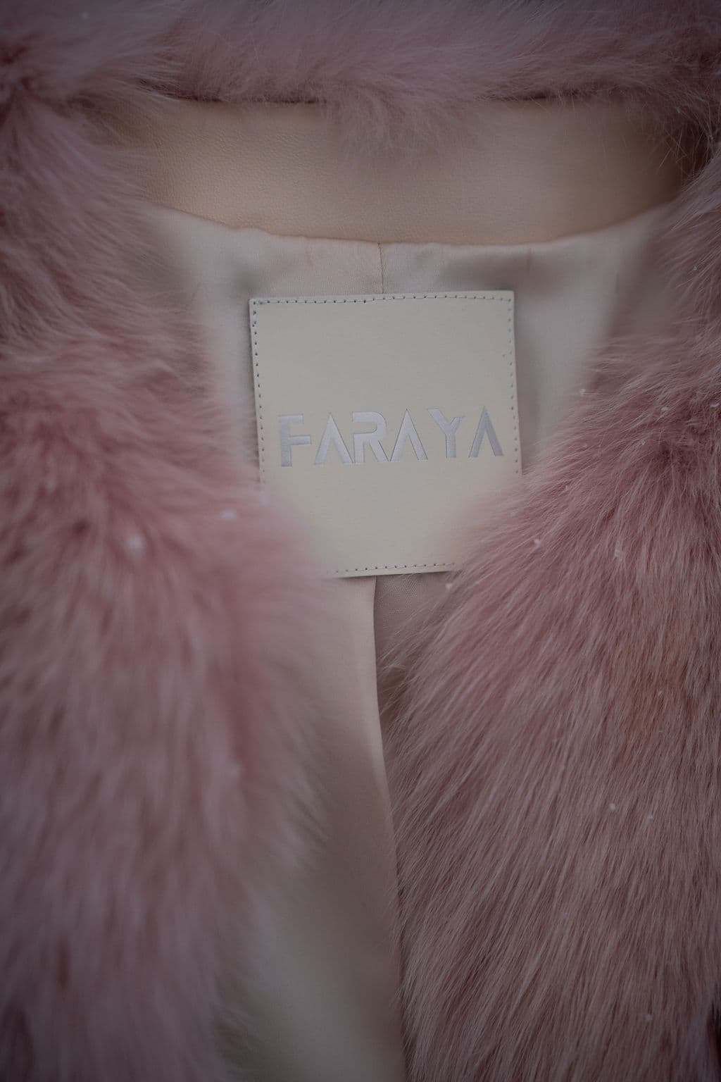 The FARAYA label, stitched inside a blush fox coat.